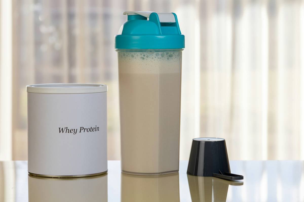 Side-by-side comparison: clean natural whey shake label vs. conventional whey with hidden additives